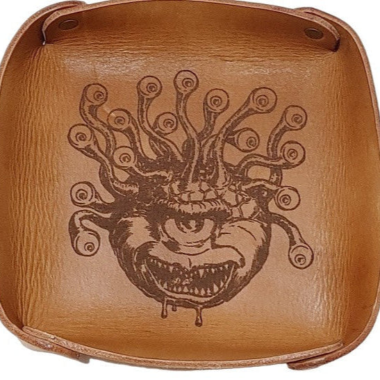 Fantasy Dice Tray Made of Vegetable Tanned Leather, hand-dyed a Medium Brown. Logo is Laser Engraved. 7″ x 7″ *Includes a standard set of 7 dice.