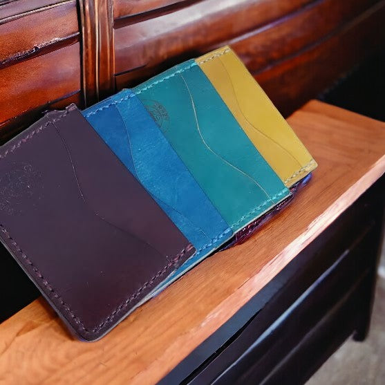 Minimalist Card Wallet - Hand-Dyed Made from Hand-dyed Vegtan Leather Designed to carry just your most important bank cards, credit cards and ID. Features 2 outside pockets, and one interior pocket. All hand-stitched.